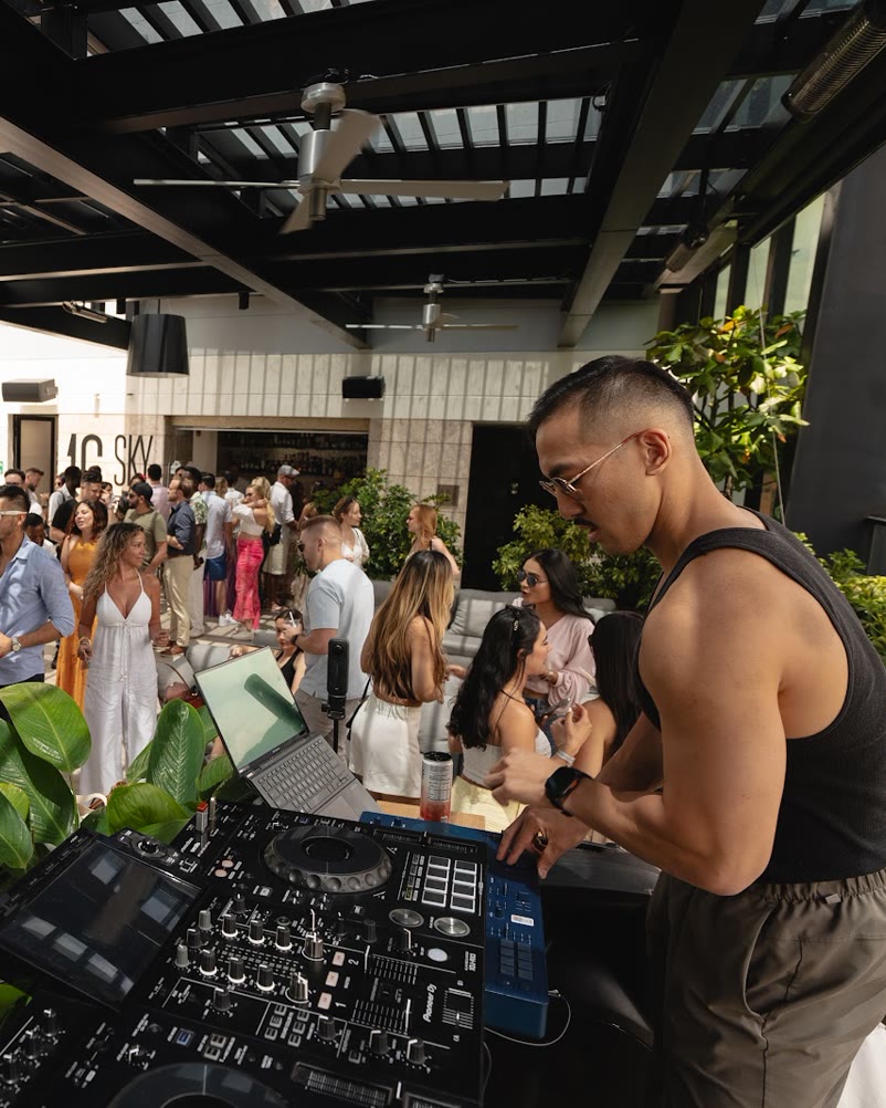 Sean Chi DJing for a packed rooftop crowd in Medellín